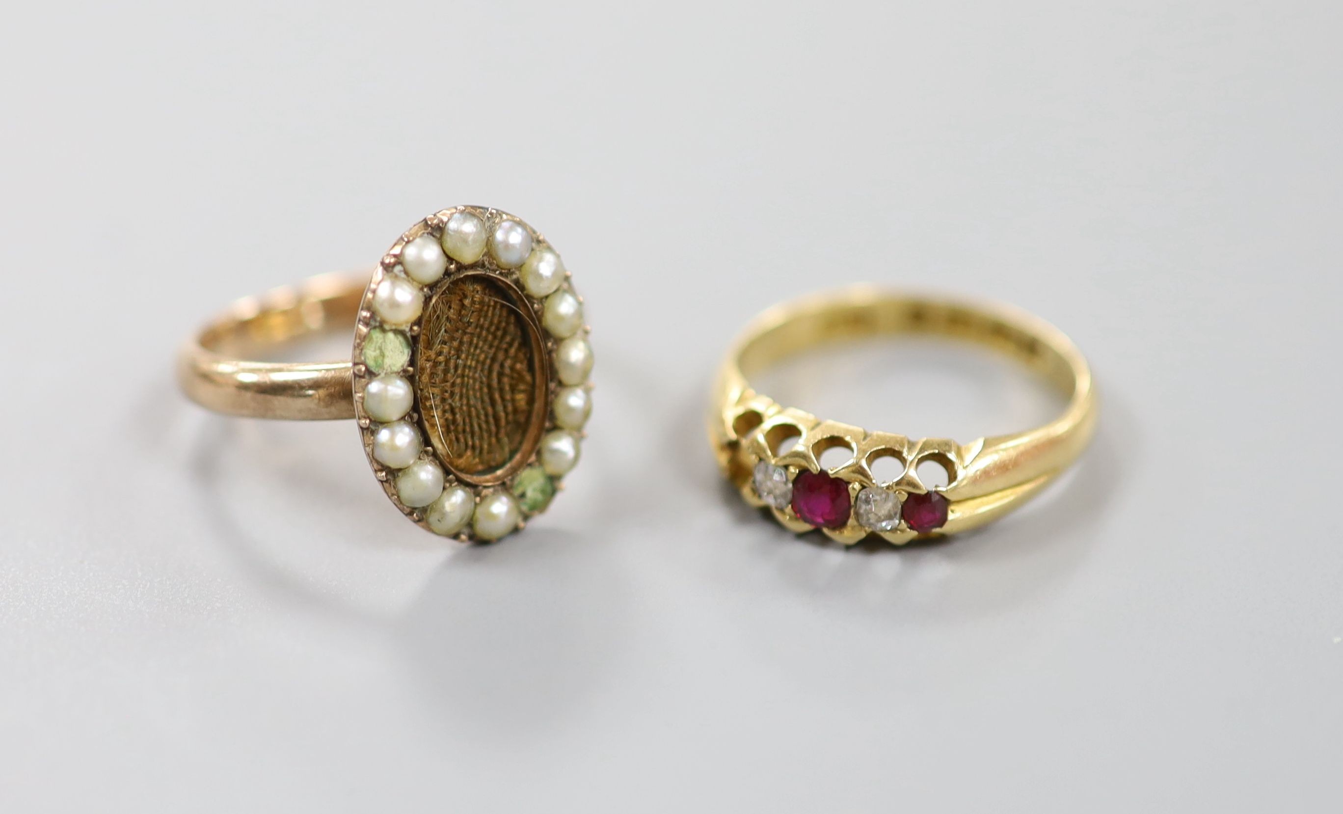 A Victorian 15ct gold, ruby and diamond set half hoop ring (stone missing), size M, gross 3.5 grams and a 19th century yellow metal and seed pearl set mourning ring, with plaited hair (glazed panel missing & two pearls m